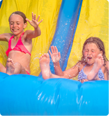 Children enjoying inflatable at community fai